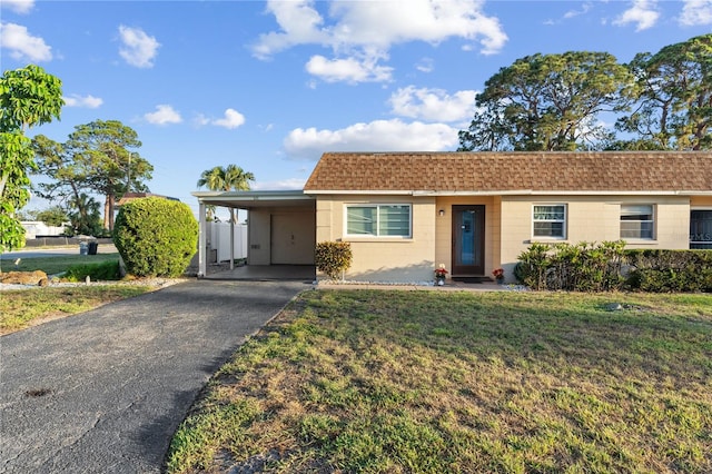 505 47th Avenue Dr W, Bradenton, FL 34207 - single story home featuring concrete block siding, a front yard, driveway, a carport, and roof with shingles