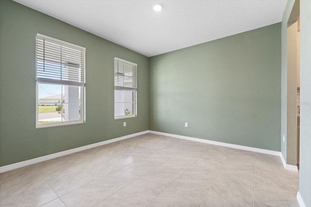 4015 Quiet Rain Ct, Palmetto, FL 34221 - unfurnished room featuring baseboards and light tile patterned flooring