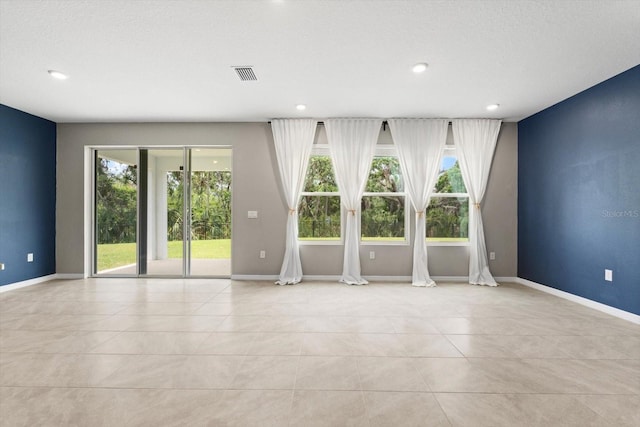 4015 Quiet Rain Ct, Palmetto, FL 34221 - spare room featuring light tile patterned floors, recessed lighting, and baseboards