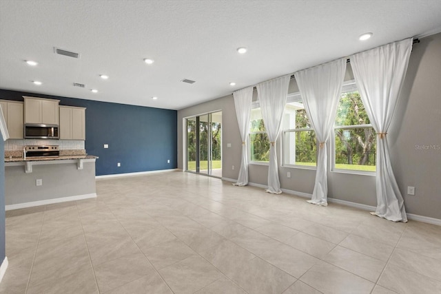 4015 Quiet Rain Ct, Palmetto, FL 34221 - unfurnished living room with recessed lighting, baseboards, and light tile patterned floors