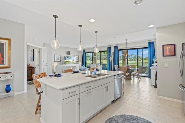 23528 Awabuki Dr Unit 101, Venice, FL 34293 - kitchen featuring a sink, appliances with stainless steel finishes, recessed lighting, white cabinets, and a kitchen island with sink