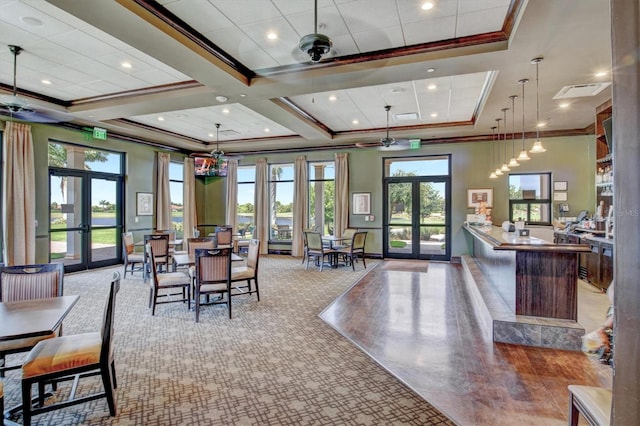23528 Awabuki Dr Unit 101, Venice, FL 34293 - dining space with french doors, crown molding, healthy amount of natural light, coffered ceiling, and baseboards