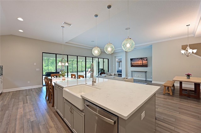 8916 Isabella Cir, Parrish, FL 34219 - kitchen with stainless steel dishwasher, a chandelier, a sink, baseboards, and hardwood / wood-style flooring