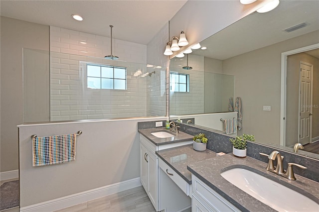 8916 Isabella Cir, Parrish, FL 34219 - bathroom featuring walk in shower, double vanity, baseboards, wood finished floors, and recessed lighting
