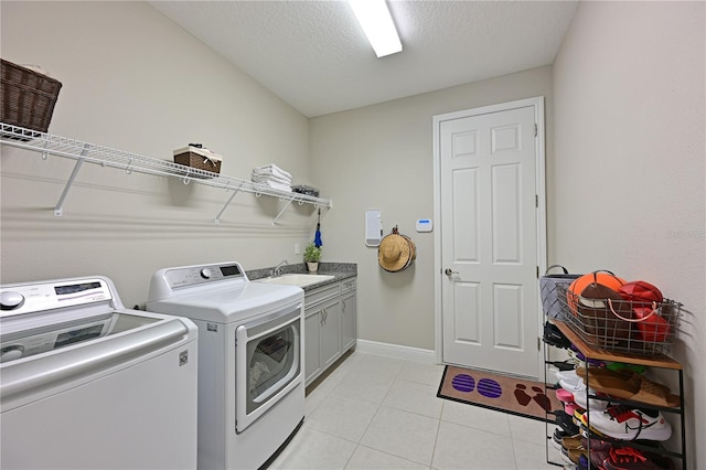 8916 Isabella Cir, Parrish, FL 34219 - clothes washing area with cabinet space, washer and clothes dryer, light tile patterned floors, a textured ceiling, and baseboards
