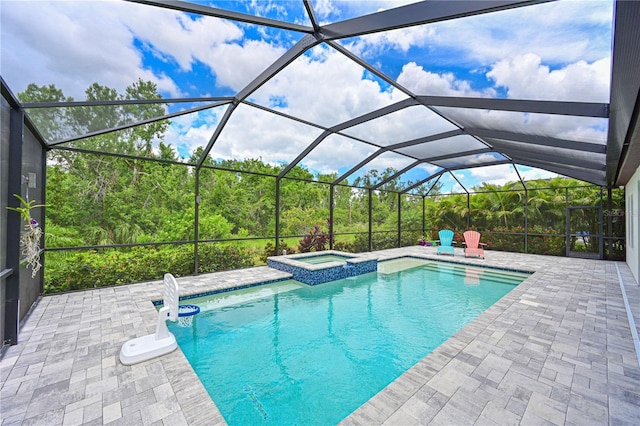 8916 Isabella Cir, Parrish, FL 34219 - view of pool featuring a patio area, a pool with connected hot tub, and glass enclosure