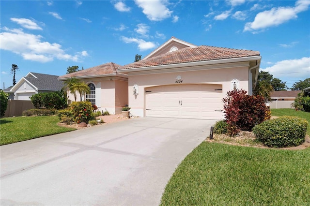 4804 Jacaranda Heights Dr, Venice, FL 34293 - view of front of property with a tiled roof, a front yard, driveway, and stucco siding
