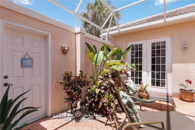 4804 Jacaranda Heights Dr, Venice, FL 34293 - property entrance with french doors and stucco siding