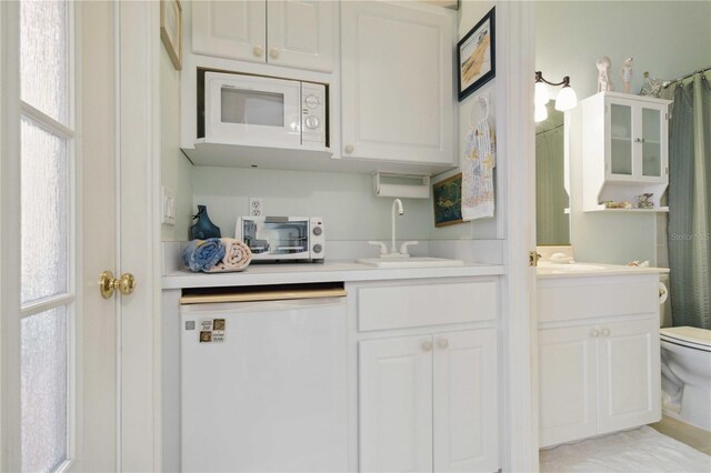 4804 Jacaranda Heights Dr, Venice, FL 34293 - kitchen featuring white appliances, light countertops, and white cabinets