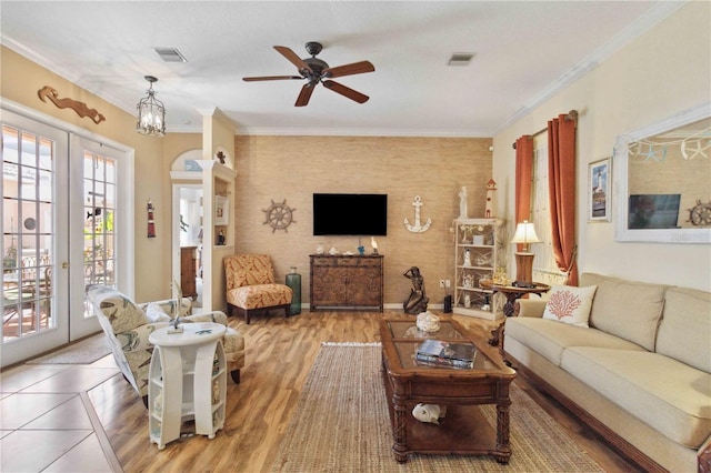 4804 Jacaranda Heights Dr, Venice, FL 34293 - living area with french doors, ceiling fan, light wood finished floors, and crown molding
