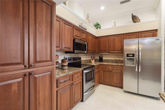 4804 Jacaranda Heights Dr, Venice, FL 34293 - kitchen with stainless steel appliances, light tile patterned flooring, decorative backsplash, stone countertops, and crown molding