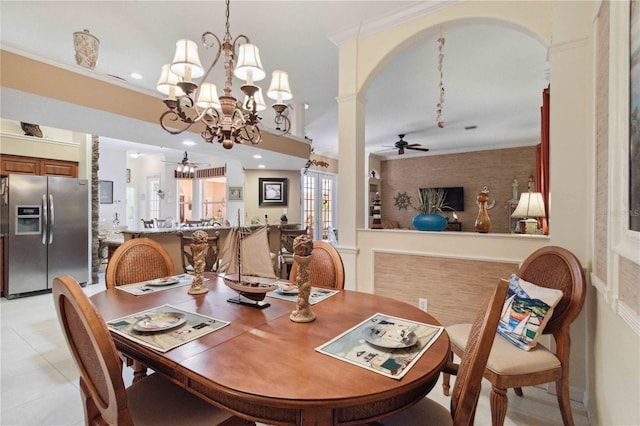 4804 Jacaranda Heights Dr, Venice, FL 34293 - dining area with ceiling fan, a chandelier, arched walkways, crown molding, and light tile patterned floors
