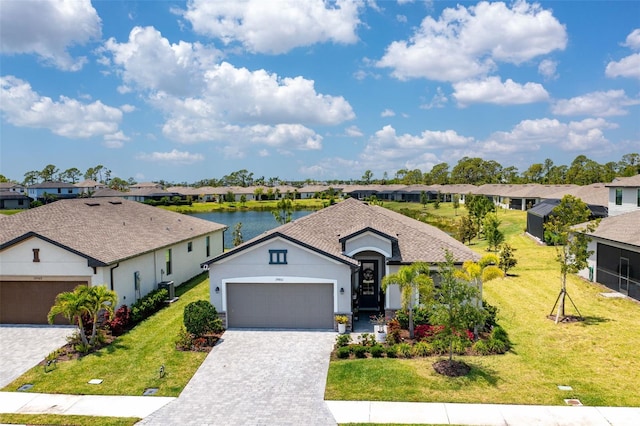 single story home featuring an attached garage, a residential view, and a front yard