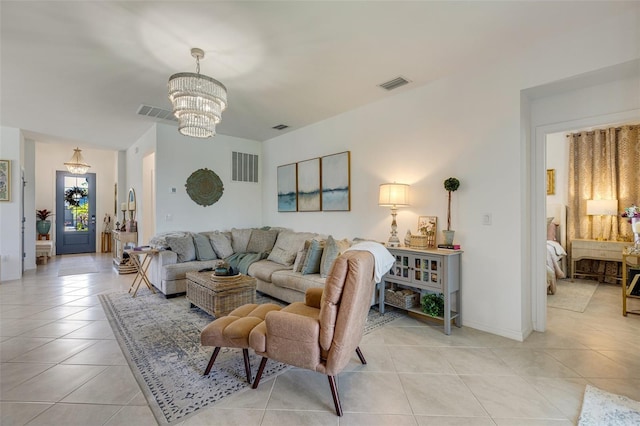 living area featuring a chandelier, light tile patterned floors, and baseboards