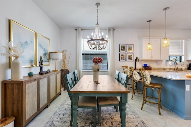 dining room featuring a chandelier and light tile patterned floors
