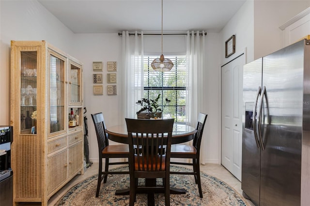 dining area with light tile patterned floors and baseboards