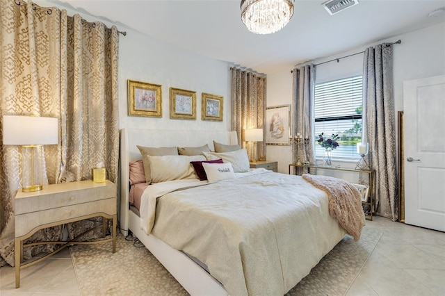 bedroom with light tile patterned flooring and a chandelier