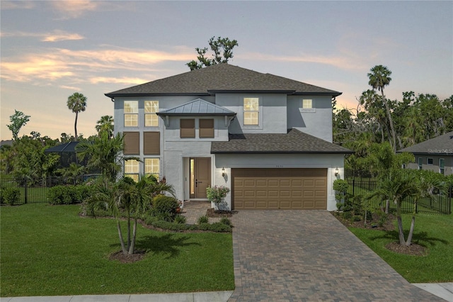 5651 Trevesta Pl, Palmetto, FL 34221 - view of front facade featuring stucco siding, decorative driveway, a garage, and a shingled roof
