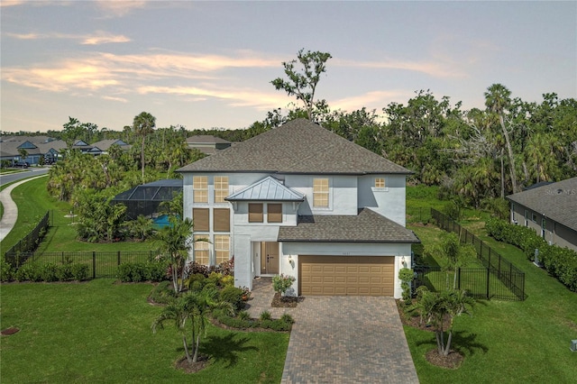 5651 Trevesta Pl, Palmetto, FL 34221 - modern home featuring stucco siding, driveway, an attached garage, and roof with shingles