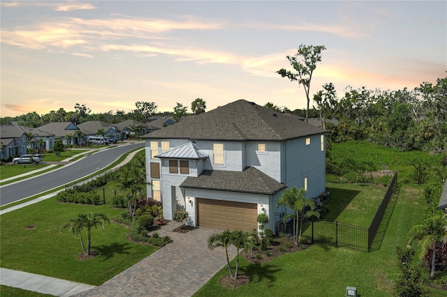 5651 Trevesta Pl, Palmetto, FL 34221 - view of front of house with stucco siding, decorative driveway, an attached garage, a residential view, and a shingled roof