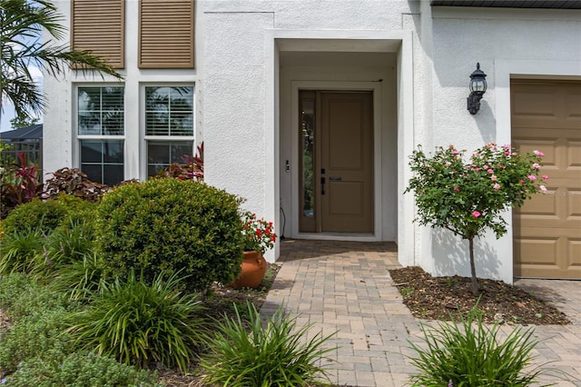5651 Trevesta Pl, Palmetto, FL 34221 - entrance to property with stucco siding and an attached garage