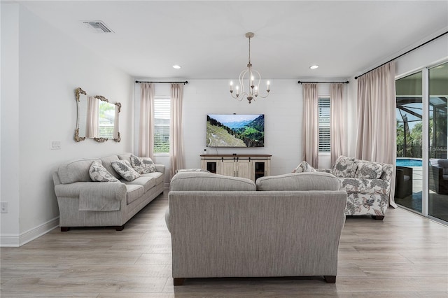 5651 Trevesta Pl, Palmetto, FL 34221 - living room featuring a chandelier, light wood-style floors, and recessed lighting