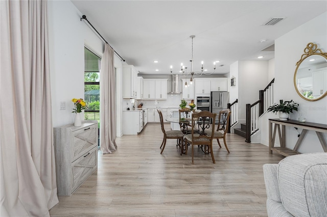 5651 Trevesta Pl, Palmetto, FL 34221 - dining space featuring stairs, a chandelier, light wood-style floors, and recessed lighting
