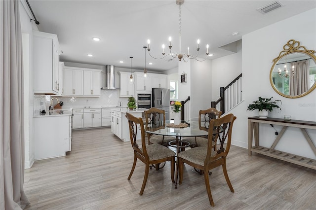 5651 Trevesta Pl, Palmetto, FL 34221 - dining room featuring a chandelier, light wood-style flooring, recessed lighting, and stairs