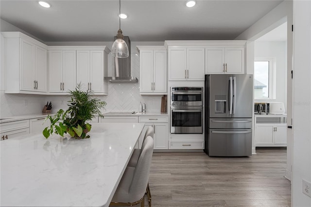 5651 Trevesta Pl, Palmetto, FL 34221 - kitchen with stainless steel appliances, white cabinetry, decorative backsplash, pendant lighting, and recessed lighting