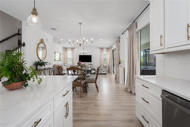 5651 Trevesta Pl, Palmetto, FL 34221 - kitchen with dishwasher, a chandelier, open floor plan, light wood-type flooring, and white cabinetry
