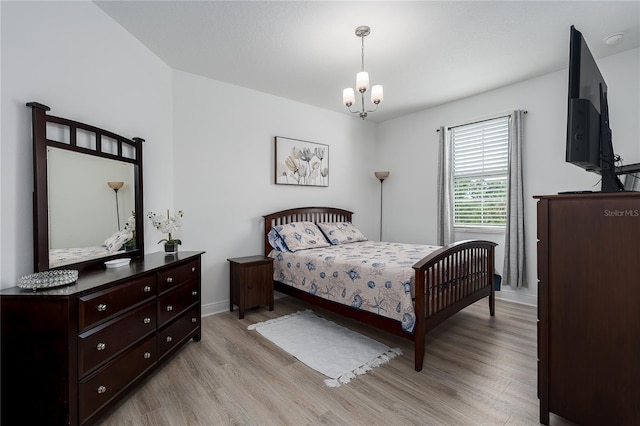5651 Trevesta Pl, Palmetto, FL 34221 - bedroom with light wood finished floors and a chandelier