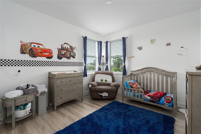 5651 Trevesta Pl, Palmetto, FL 34221 - bedroom featuring a crib and wood finished floors