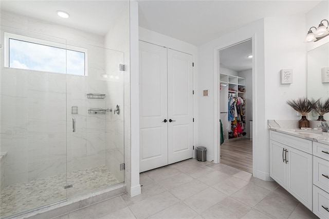 5651 Trevesta Pl, Palmetto, FL 34221 - full bath featuring vanity, a shower stall, tile patterned flooring, and a spacious closet