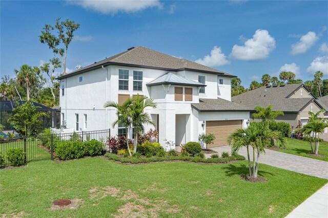 5651 Trevesta Pl, Palmetto, FL 34221 - view of front facade featuring stucco siding, driveway, and a shingled roof
