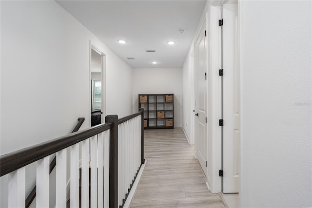 5651 Trevesta Pl, Palmetto, FL 34221 - hallway with an upstairs landing, light wood-style flooring, and recessed lighting