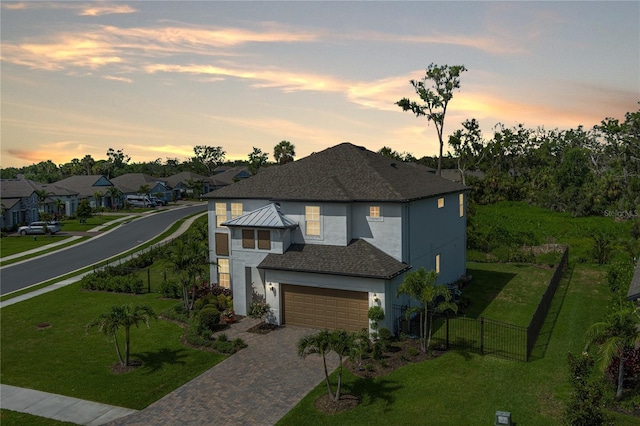 5651 Trevesta Pl, Palmetto, FL 34221 - contemporary house with stucco siding, decorative driveway, a residential view, and a garage