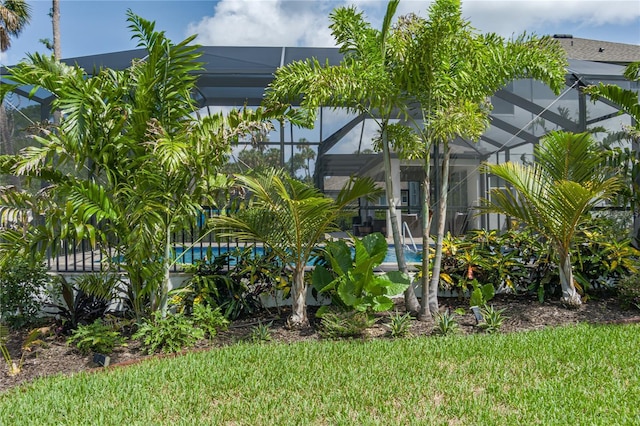 5651 Trevesta Pl, Palmetto, FL 34221 - back of house with glass enclosure, an outdoor pool, and a lawn