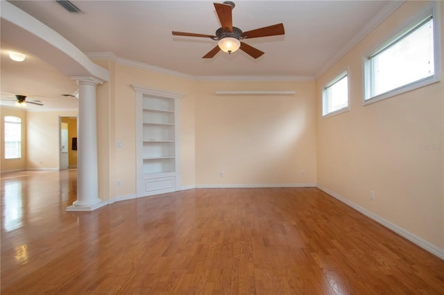6307 Laurel Creek Trl, Ellenton, FL 34222 - empty room with decorative columns, a ceiling fan, light wood-type flooring, built in features, and crown molding