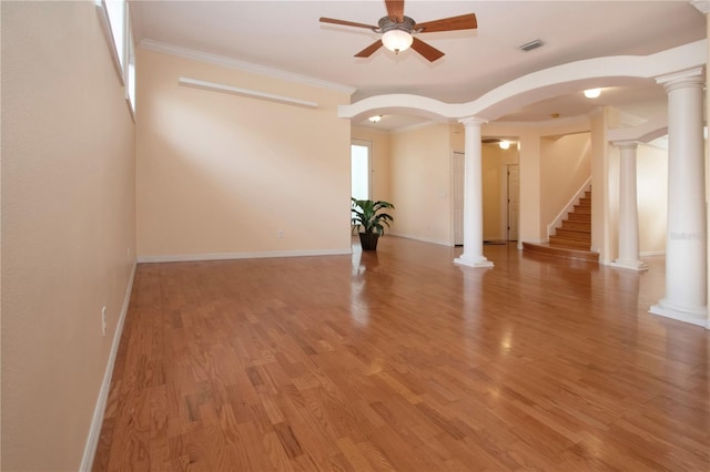 6307 Laurel Creek Trl, Ellenton, FL 34222 - spare room with a ceiling fan, arched walkways, decorative columns, light wood-style floors, and crown molding
