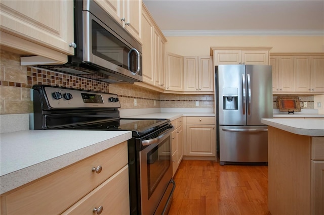 6307 Laurel Creek Trl, Ellenton, FL 34222 - kitchen with stainless steel appliances, light countertops, light brown cabinets, decorative backsplash, and ornamental molding