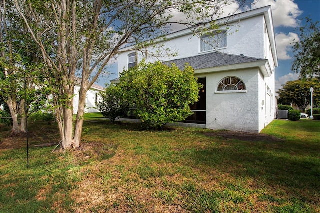 6307 Laurel Creek Trl, Ellenton, FL 34222 - back of property featuring a lawn, cooling unit, stucco siding, and roof with shingles