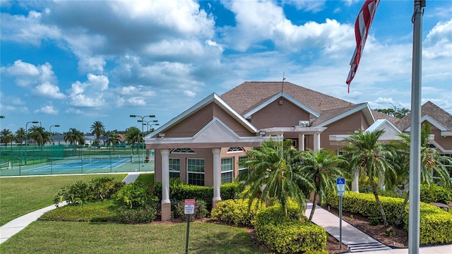6307 Laurel Creek Trl, Ellenton, FL 34222 - view of front of home with a tennis court and stucco siding