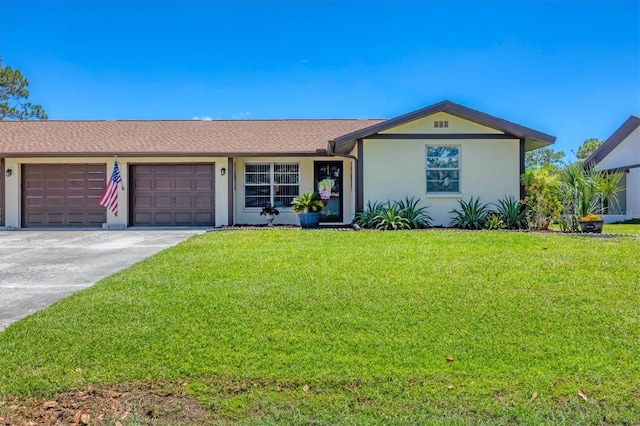 217 High Point Dr Unit 217A, Englewood, FL 34223 - single story home featuring a garage, a front yard, driveway, and stucco siding