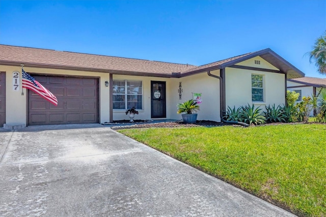 217 High Point Dr Unit 217A, Englewood, FL 34223 - single story home with stucco siding, a front lawn, a garage, and concrete driveway