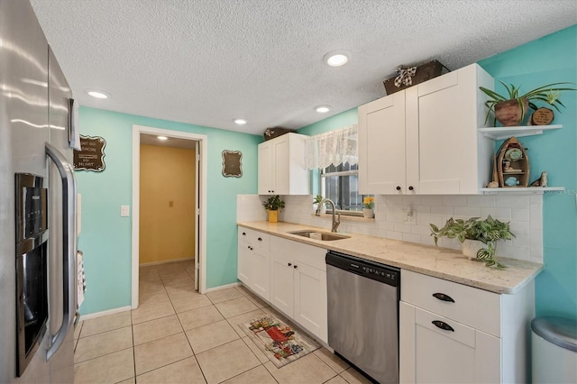 217 High Point Dr Unit 217A, Englewood, FL 34223 - kitchen with appliances with stainless steel finishes, a sink, tasteful backsplash, white cabinets, and recessed lighting