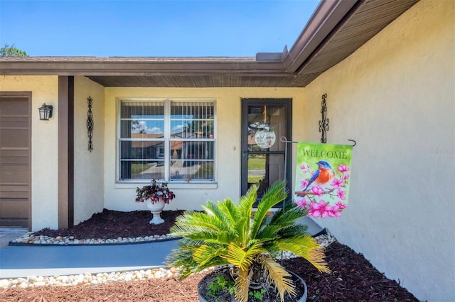 217 High Point Dr Unit 217A, Englewood, FL 34223 - view of exterior entry with stucco siding and covered porch