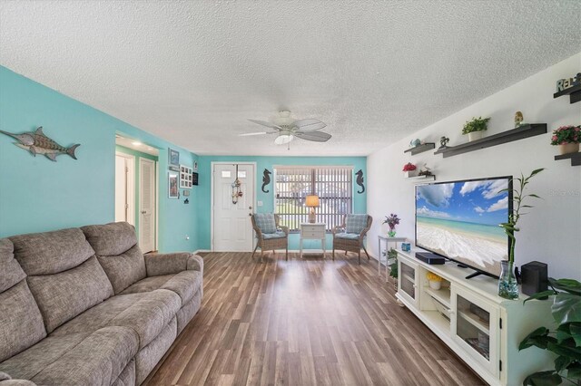 217 High Point Dr Unit 217A, Englewood, FL 34223 - living room with a textured ceiling, wood finished floors, and a ceiling fan