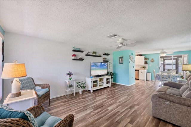 217 High Point Dr Unit 217A, Englewood, FL 34223 - living room featuring a ceiling fan, wood finished floors, a textured ceiling, and baseboards
