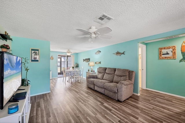 217 High Point Dr Unit 217A, Englewood, FL 34223 - living room featuring a ceiling fan, wood finished floors, a textured ceiling, and baseboards