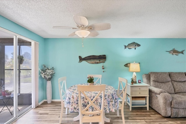 217 High Point Dr Unit 217A, Englewood, FL 34223 - dining room with a textured ceiling, wood finished floors, a ceiling fan, and baseboards